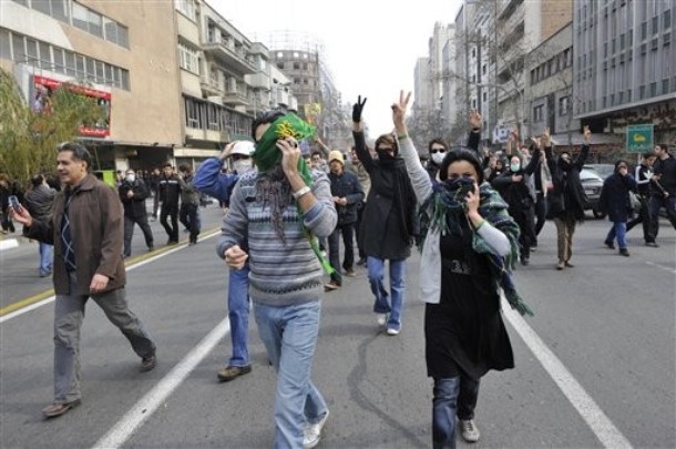 This photo, taken by an individual not employed by the Associated Press and obtained by the AP outside Iran shows Iranian protestors flashing the victory sign, as they cover their faces to avoid to be identified by security during anti-government protest in Tehran, Iran, Sunday, Dec. 27, 2009. (AP Photo) EDITORS NOTE AS A RESULT OF AN OFFICIAL IRANIAN GOVERNMENT BAN ON FOREIGN MEDIA COVERING SOME EVENTS IN IRAN, THE AP WAS PREVENTED FROM INDEPENDENT ACCESS TO THIS EVENT
